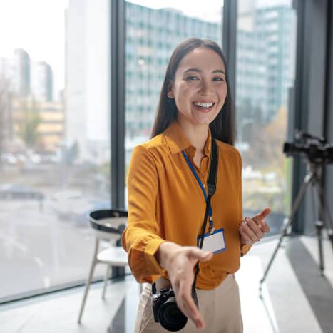 dark-haired-young-cute-reporter-with-camera-smilin-2024-10-13-20-03-30-utc (1)