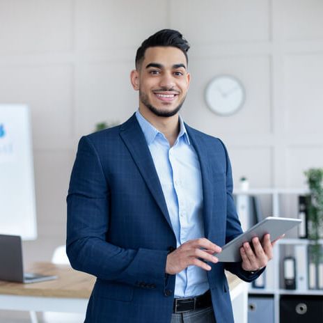 happy-male-office-worker-in-formal-suit-holding-ta-2023-11-27-04-54-41-utc (1)